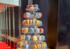 Eine große Etagere mit lauter bunten Macarons, auf die jeweils klein das Gebäude der Oper aufgedruckt ist.